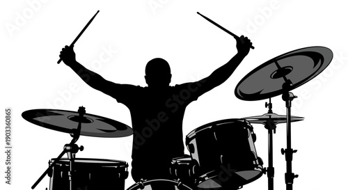 Silhouette of a drummer celebrating with drumsticks raised high behind a drum kit.