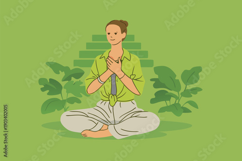 Woman practicing meditation and breathing exercises in a green nature environment.