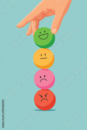 Hand putting a green happy face ball on a stack of emotional spheres.