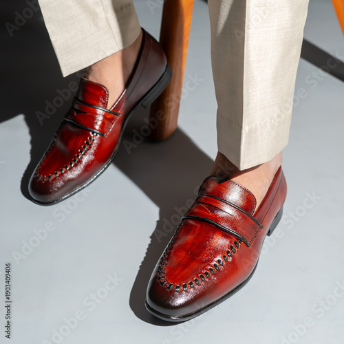 Obraz na plátně Stylish man wearing elegant red leather loafers with khaki pants