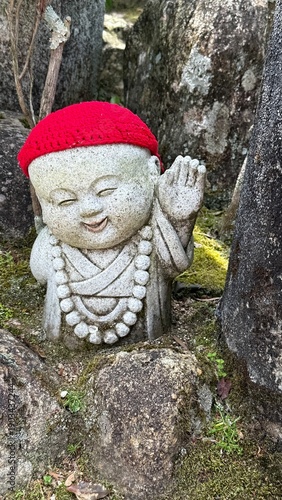 Stone statue with red woolen hat in Japan  buddhist temple, Daishoin  bodhisattva 