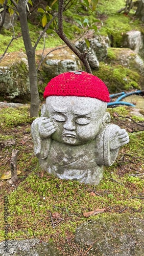 Stone statue with red woolen hat in Japan  buddhist temple, Daishoin  bodhisattva 