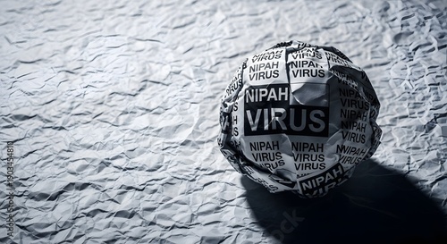 Nipah Virus text on crumpled paper ball, symbolizing global health outbreak, pandemic threat, and medical crisis news.