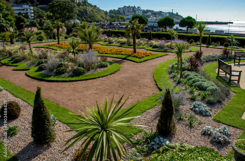 Fototapeta premium Italian gardens at Torre Abbey Park and meadows. Landmark tourist attraction Tropical palms, Mediterranean plants showcase the English Riviera. 