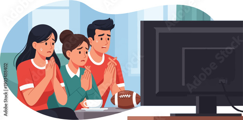 Three people anxiously watch a football game on television, hands clasped