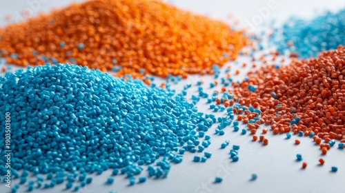 Close up of colorful plastic granules or pellets, orange and blue, used for manufacturing and recycling. Industrial raw materials and polymer concept.