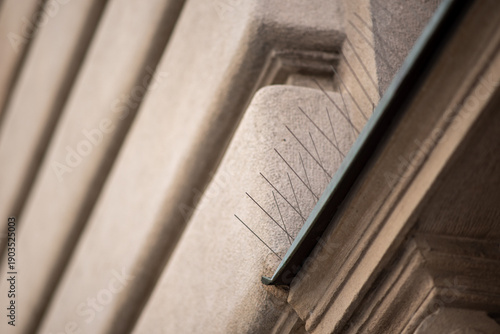 Bird deterrent spikes on stone building ledge