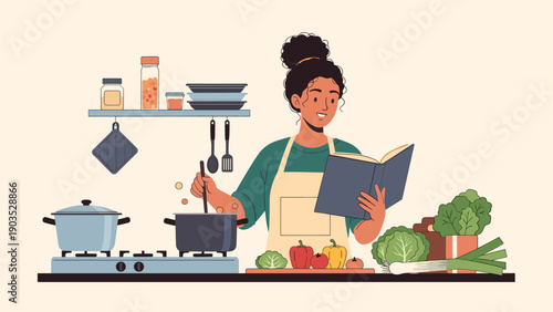 Cheerful woman with curly hair happily cooking in a modern kitchen, stirring a pot on the stove while consulting a recipe in a cookbook.
