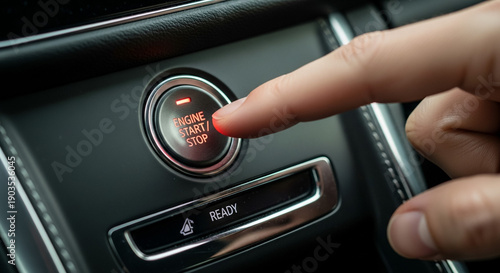 Close-up of Hand Pressing Engine Start Stop Button in Car