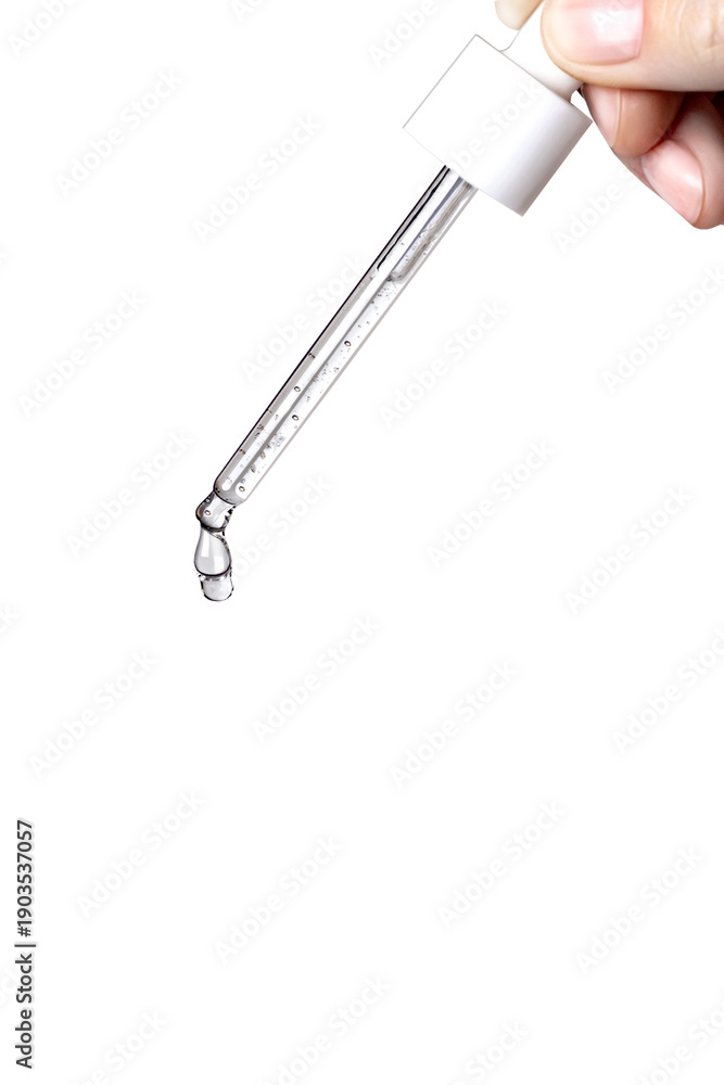 Fototapeta premium Pipette with serum in hand. Drips drop isolated on white background, copy space vertical photo close up
