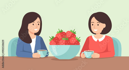 Two women enjoying coffee and a bowl of strawberries at a table
