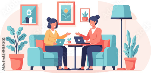 Two women sitting on couches, working on laptops in a cozy, decorated room