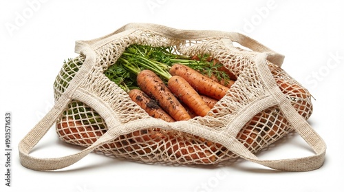 Freshly harvested organic carrots with vibrant green tops are visibly contained within a reusable beige cotton string mesh bag, perfectly isolated on 