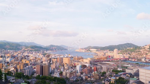 Nagasaki, Japan. Aerial timelapse made from a hill in Nagasaki, Japan, with a view over the entire center, including the bay and the hills. Cloudy and sunny day in summer