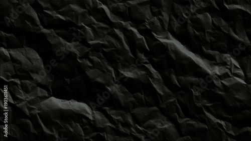 Crumpled black paper texture background closeup view
