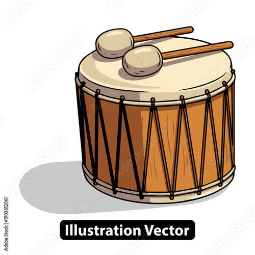 A traditional drum with drumsticks lies on a simple surface in a cultural setting viewed from the side