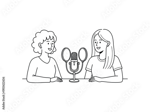 Two women with headphones recording a podcast interview with professional microphone at table
