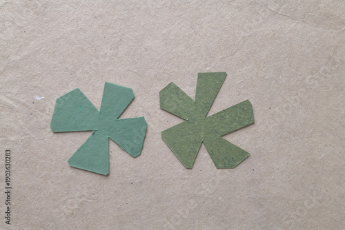 abstract green paper astral shapes on brown