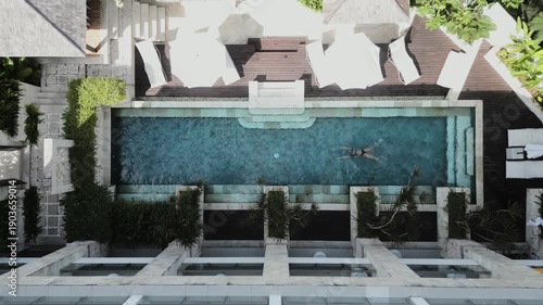 Woman jumps headlong into a pool and dives