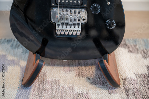 Vászonkép Electric guitar body detail with tremolo bridge on wooden stand