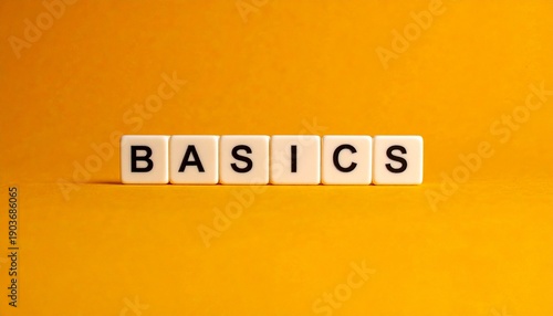 “Basics” Word on White Tiles with Orange Background Showcasing Simplicity, Foundational Concepts, and Educational Design
