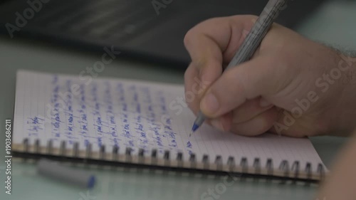 Wallpaper Mural Close-Up Of Hand Writing In A Spiral Notebook With Blue Pen On Desk For Note Taking And Study Torontodigital.ca