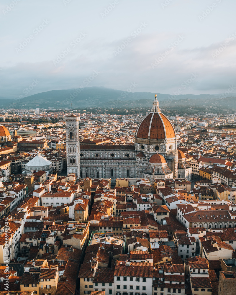 Obraz premium Aerial view of Florence featuring the iconic Duomo cathedral of Santa Maria del Fiore surrounded by the historic city center. Classic Tuscan architecture and Renaissance heritage captured from above