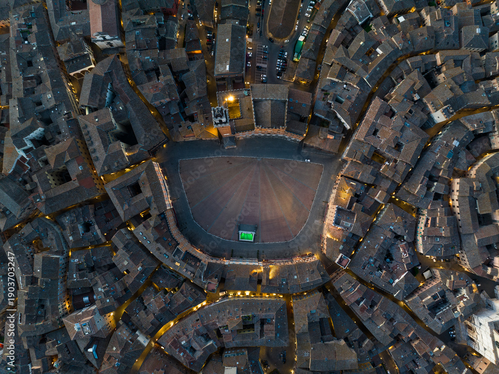 Fototapeta premium Vertical top down aerial view of Piazza del Campo, the famous shell-shaped medieval square in Siena, Tuscany. Unique urban design and historic architecture seen from above