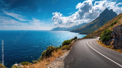 Seaside Serenity: A scenic coastal road winds along the edge of the turquoise sea, offering breathtaking views of mountains, sky, and sea.