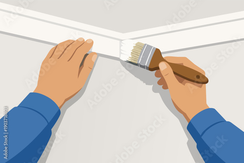 Hands painting white trim molding along a wall, renovating home interior