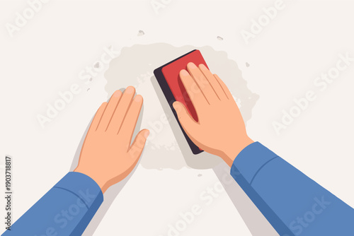 Person sanding wall surface with block for home renovation and repair