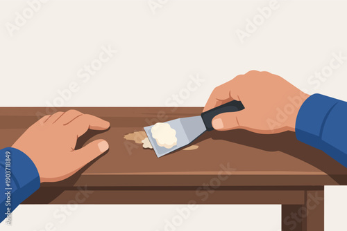 Hand applying wood putty with a scraper, repairing furniture for home renovation