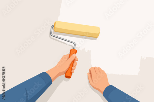 Hands painting wall white with a paint roller renovating home interior
