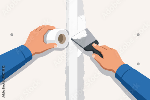 Drywall worker hands applying joint compound and taping plasterboard seams