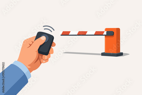 Hand holding remote control opening an automatic car barrier gate