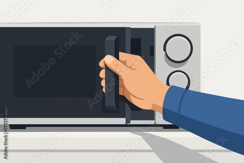 Hand opening microwave oven door for cooking or heating food in kitchen