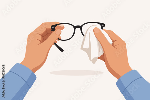 Hands holding and cleaning eyeglasses with a cloth for clear vision