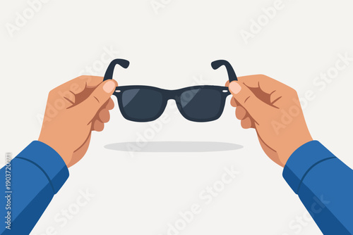 Hands holding black sunglasses, symbolizing summer protection and eye care