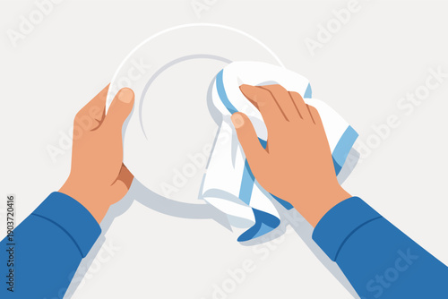 Hands drying a clean plate with a kitchen towel after washing dishes