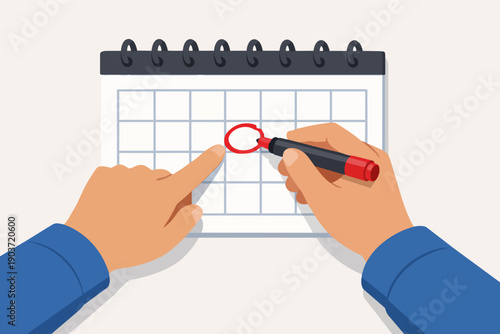 Hands marking a date on a calendar, planning an important event or deadline