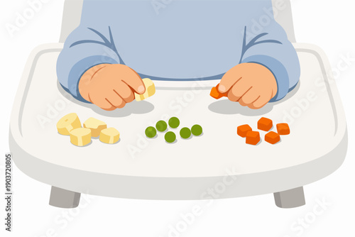 Baby learning self-feeding with finger food on a high chair tray, developing motor skills