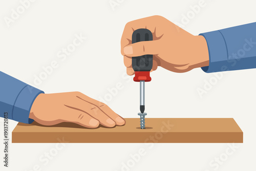 Hand using screwdriver turning screw into wood plank for repair or assembly work