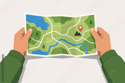 Hands holding a folded outdoor map finding destination and planning adventure