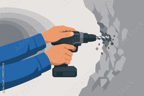 Hands using an electric drill, drilling into a concrete wall for construction work