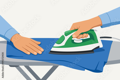 Hands ironing blue fabric on an ironing board, doing daily household chores