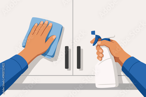Hands cleaning kitchen cabinets with spray bottle and cloth