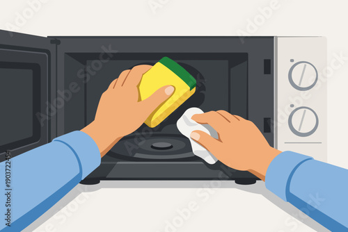 Cleaning microwave oven interior at home using a sponge and cloth for hygiene