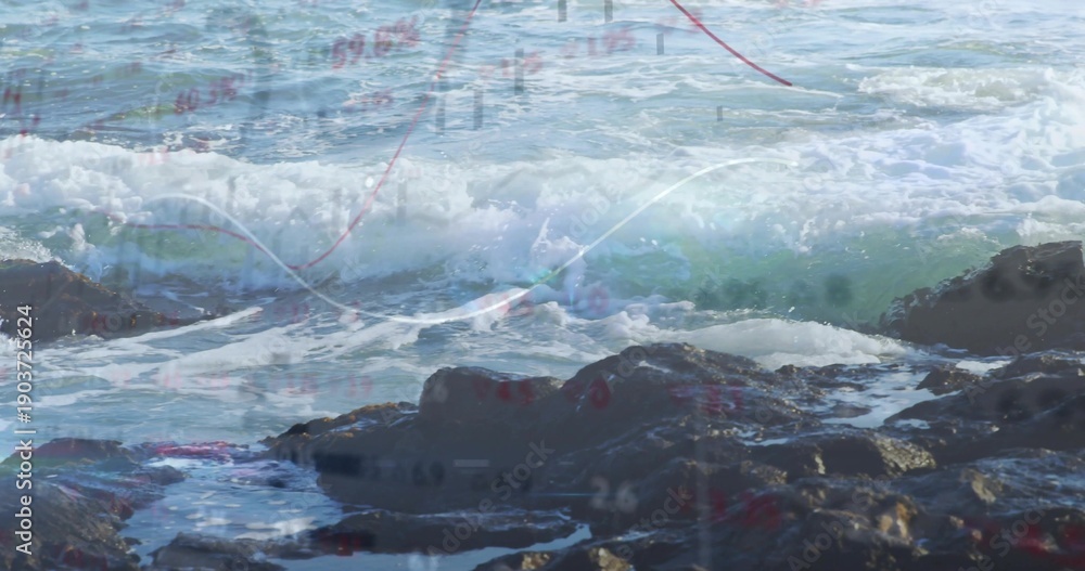 Fototapeta Crashing wave rolling onto rocky shore, splashing tide pools with foam and chart overlay