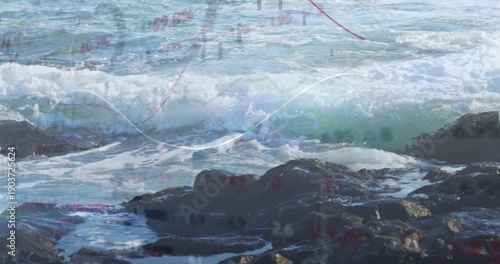 Crashing wave rolling onto rocky shore, splashing tide pools with foam and chart overlay