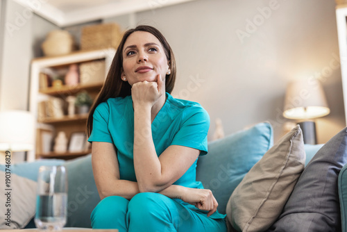 Calm, thinking and a nurse or woman on the sofa to relax from a career in healthcare in a house. Smile, peace and a medical employee or doctor with an idea or vision on the couch for a memory.
